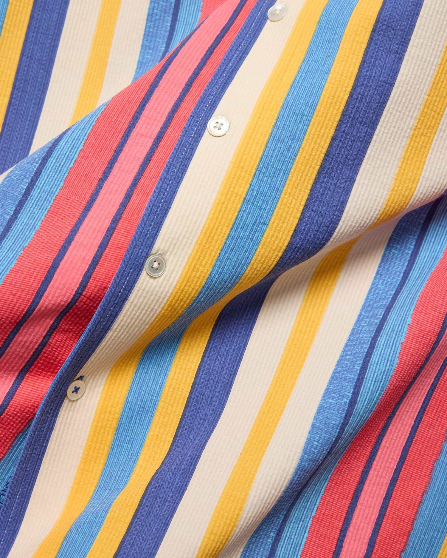 Mens Hubert Knit Shirt, vibrant multi-color vertical stripes in red, pink, blue, yellow, and cream, with a textured knit fabric and white buttons.