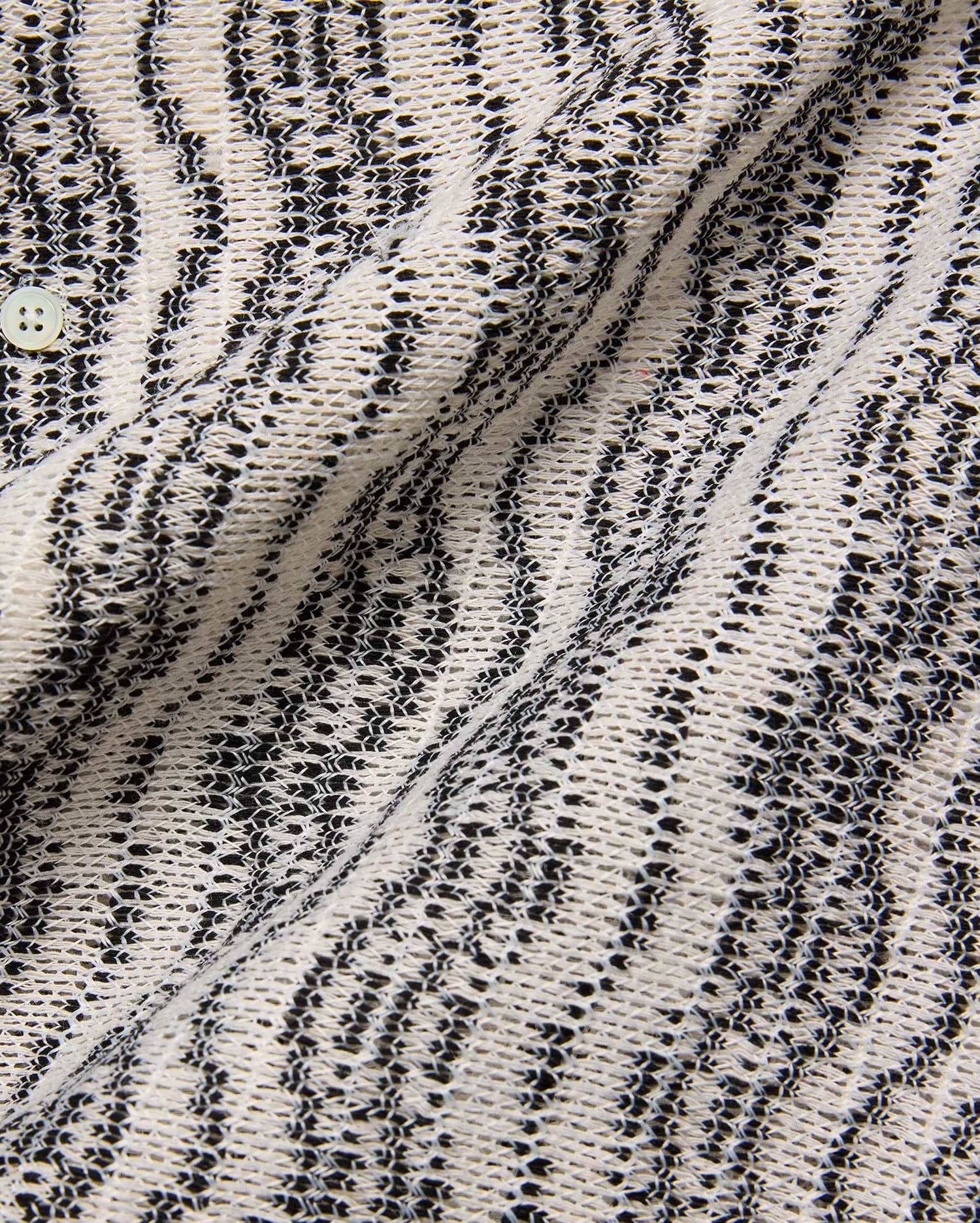 Mens Dave Crochet Shirt featuring an intricate open-weave knit in cream and black, forming a textured striped pattern, with a visible light button closure.