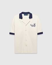 Mens Kelly Oversized Shirt in cream knit, featuring a navy spread collar and sleeve cuffs, with an embroidered navy Psycho Bunny skull logo and script on the left chest.
