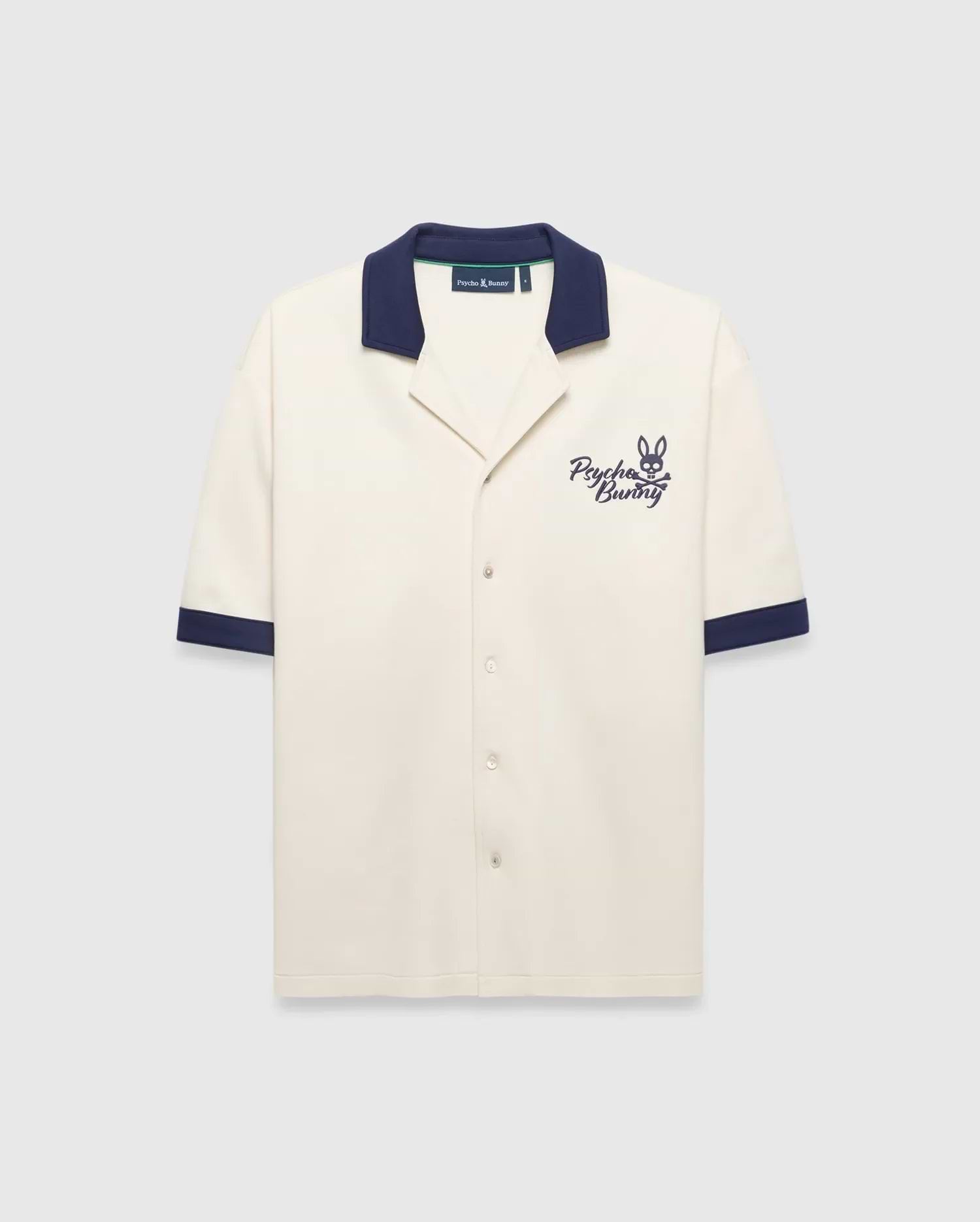Mens Kelly Oversized Shirt in cream knit, featuring a navy spread collar and sleeve cuffs, with an embroidered navy Psycho Bunny skull logo and script on the left chest.