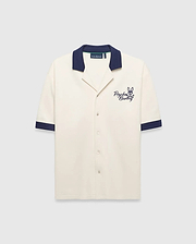 Mens Kelly Oversized Shirt in cream knit, featuring a navy spread collar and sleeve cuffs, with an embroidered navy Psycho Bunny skull logo and script on the left chest.