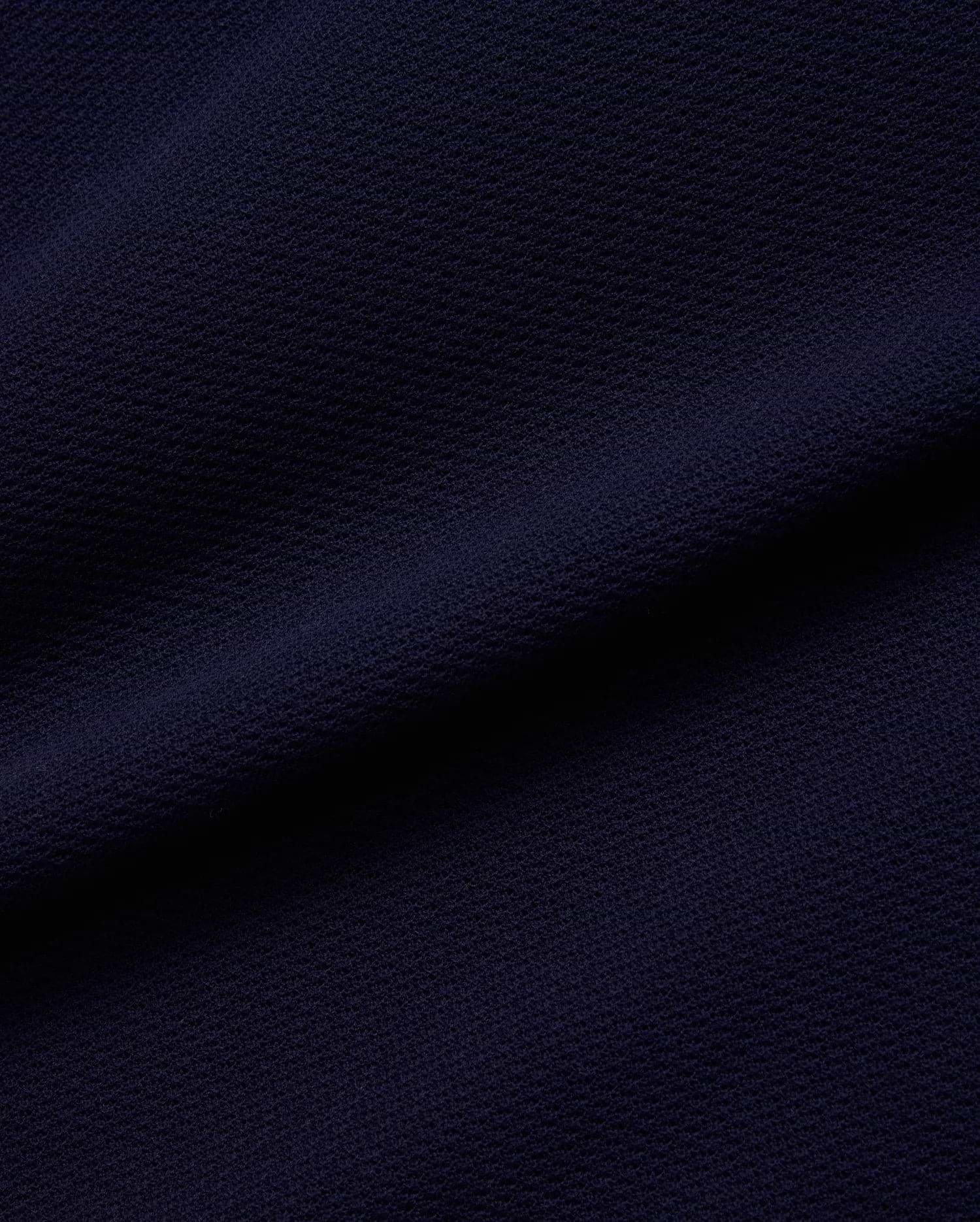 Mens Peter Knit Vest in a rich, dark navy blue, featuring a premium, finely textured knit fabric with a distinct, subtle pique-like weave, offering a sophisticated and breathable feel.