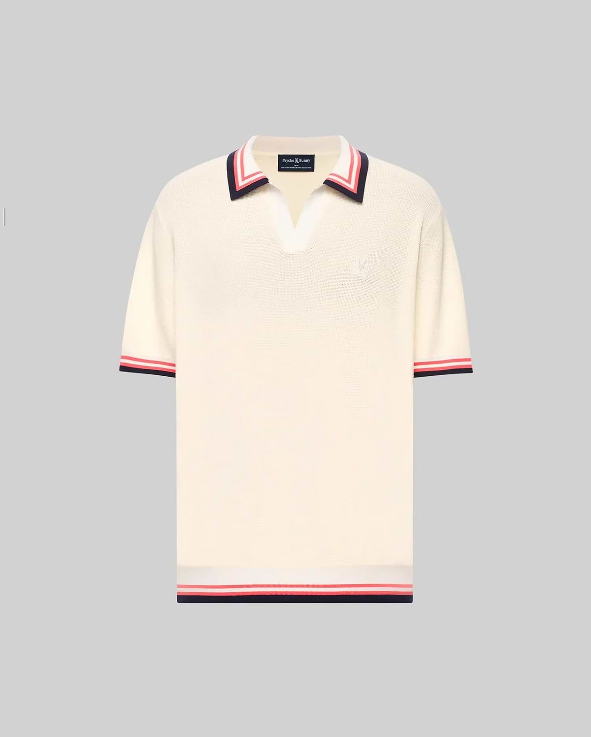 The Psycho Bunny MENS CARTER JOHNNY COLLAR KNIT POLO (MT0400093) is a cream, 100% cotton short-sleeve polo with a deep V-neck Johnny collar and red/navy colorblocked stripes on the collar, sleeves, and hem, shown on a light gray background. (5)