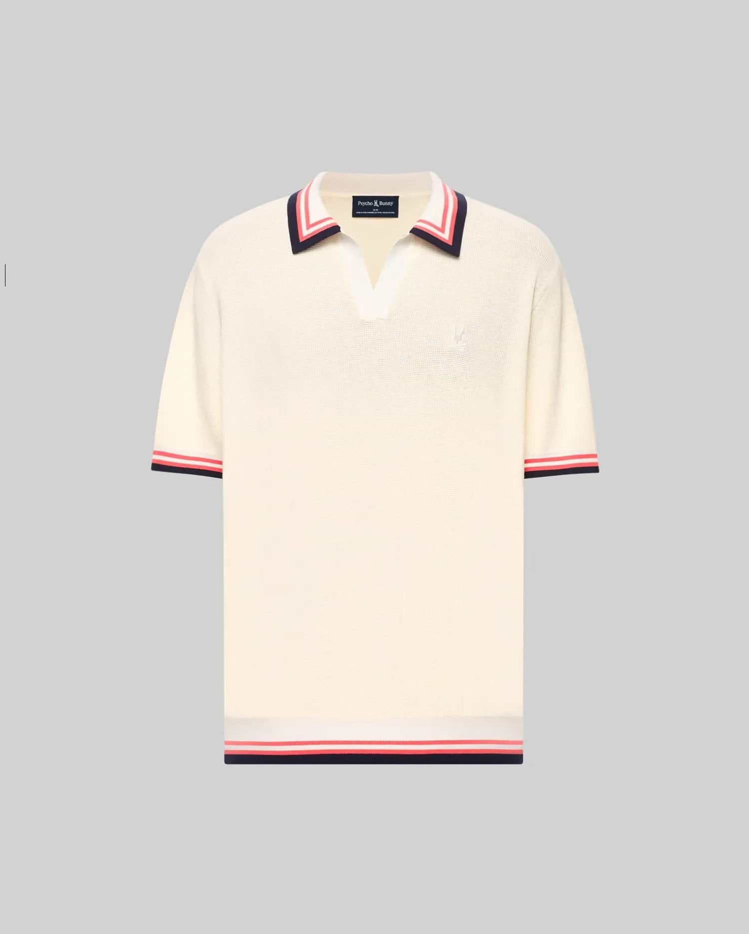 The Psycho Bunny MENS CARTER JOHNNY COLLAR KNIT POLO (MT0400093) is a cream, 100% cotton short-sleeve polo with a deep V-neck Johnny collar and red/navy colorblocked stripes on the collar, sleeves, and hem, shown on a light gray background. (5)