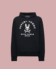 The Psycho Bunny MENS ARCHIVE HOODIE - MT0500009 is a black French terry hoodie with a large white bunny skull and crossbones graphic, “PSYCHO BUNNY” above and “BOLD SINCE 2005” below, plus front pocket and drawstring hood.