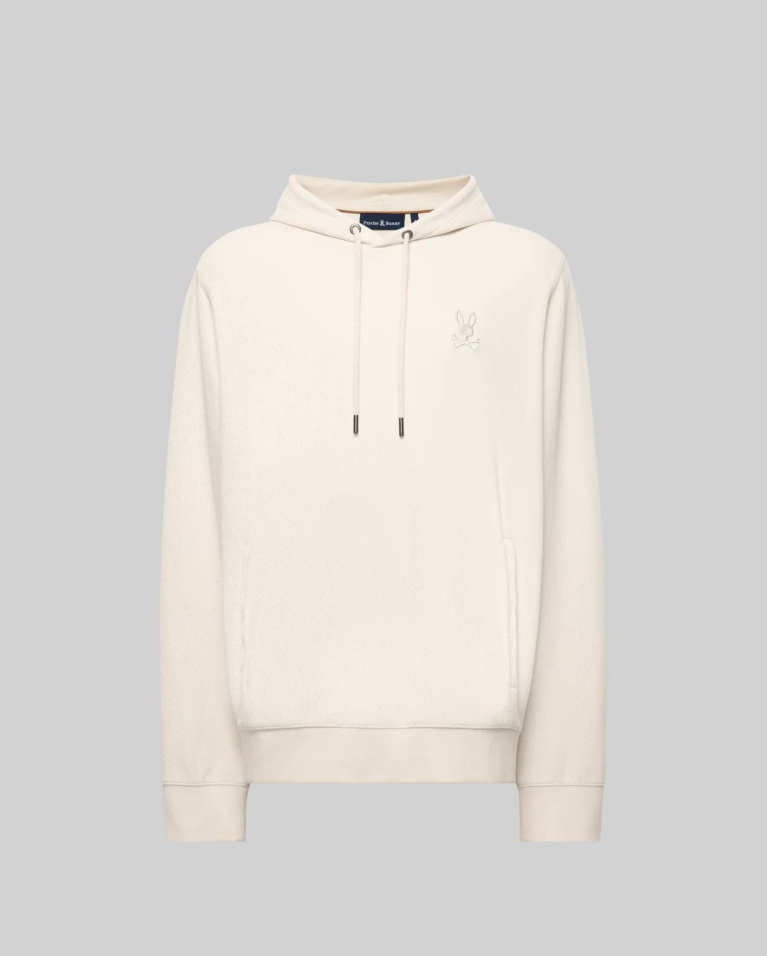 The MENS KAI TWILL TEXTURE HOODIE - MT0500019 by Psycho Bunny features a cream color, drawstrings, a small embroidered Bunny logo on the left chest, and ribbed cuffs and hem, shown against a light gray background.