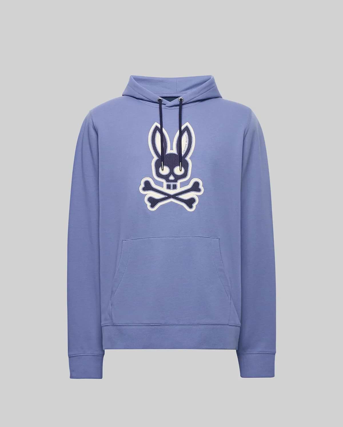 The Psycho Bunny MENS RYDER EMBROIDERED BUNNY PATCH HOODIE - MT0500029 is a light purple hoodie with a front pocket, featuring a large black and white Bunny patch above crossed bones—ideal for cozy loungewear.