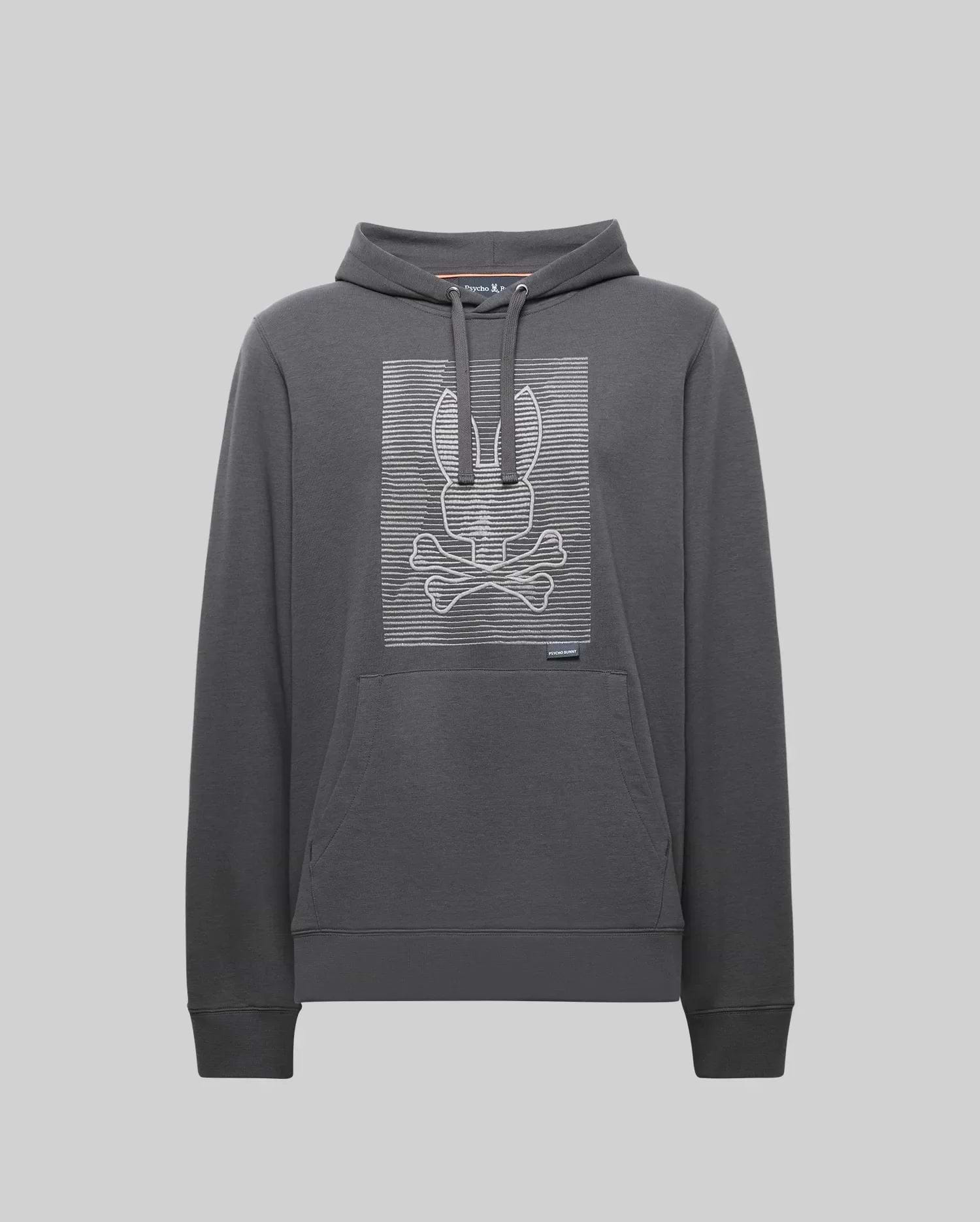 The Psycho Bunny MENS GRANT HOODIE - MT0500032 is a dark gray premium cotton hoodie featuring a front pouch pocket and a bold, digital-inspired bunny skull and crossbones outlined with white horizontal lines on the chest.