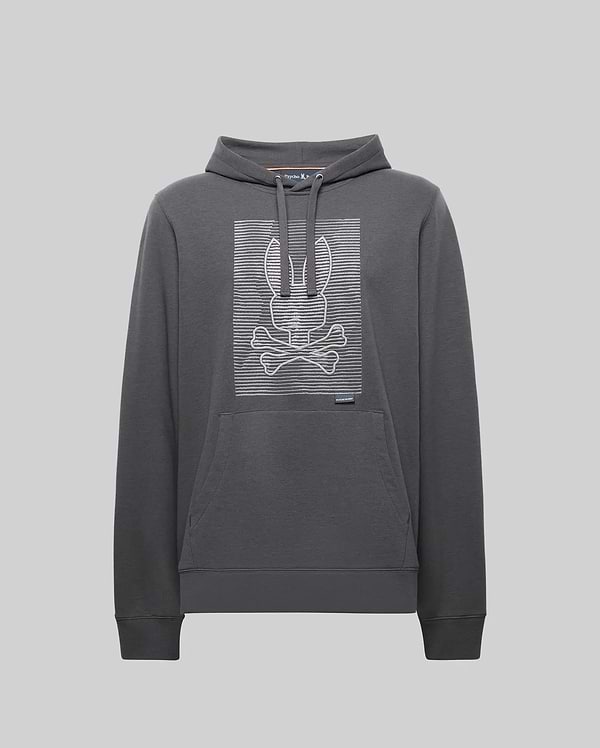The Psycho Bunny MENS GRANT HOODIE - MT0500032 is a dark gray premium cotton hoodie featuring a front pouch pocket and a bold, digital-inspired bunny skull and crossbones outlined with white horizontal lines on the chest.