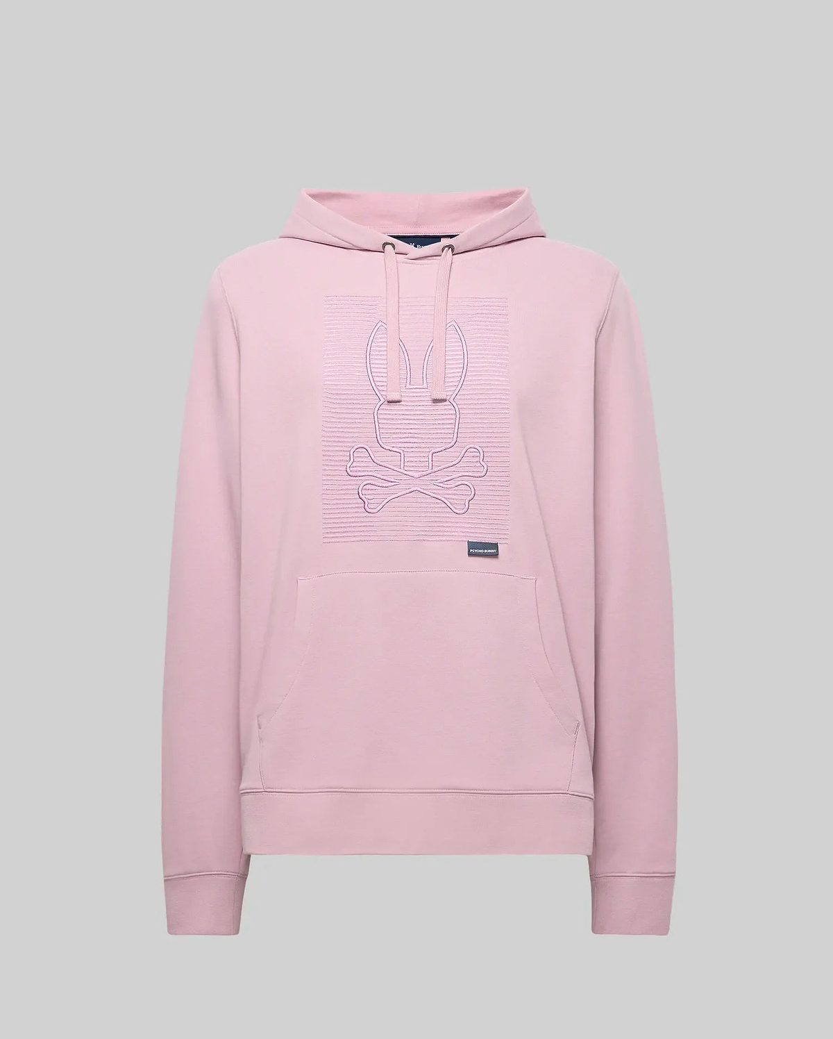 The Psycho Bunny MENS GRANT HOODIE - MT0500032 is a light pink premium cotton-blend hoodie with long sleeves, a front pocket, and a raised zig-zag embroidered bunny head above crossed bones on the chest. Plain gray background.