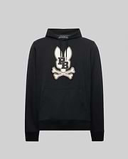The Psycho Bunny MENS WADE CORD PATCH HOODIE - MT0500112 is a black premium cotton-blend hoodie featuring a bold bunny head with long ears above crossed bones and "L" and "B" on the chest, shown on a plain gray background.