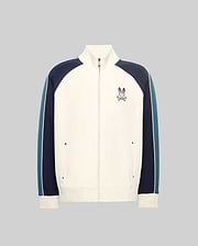 Cream full-zip track jacket with navy and teal color-block sleeves featuring a white stripe, classic fit, smooth knit, stand collar, and an embroidered Psycho Bunny skull logo on the left chest.