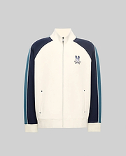 Cream full-zip track jacket with navy and teal color-block sleeves featuring a white stripe, classic fit, smooth knit, stand collar, and an embroidered Psycho Bunny skull logo on the left chest.