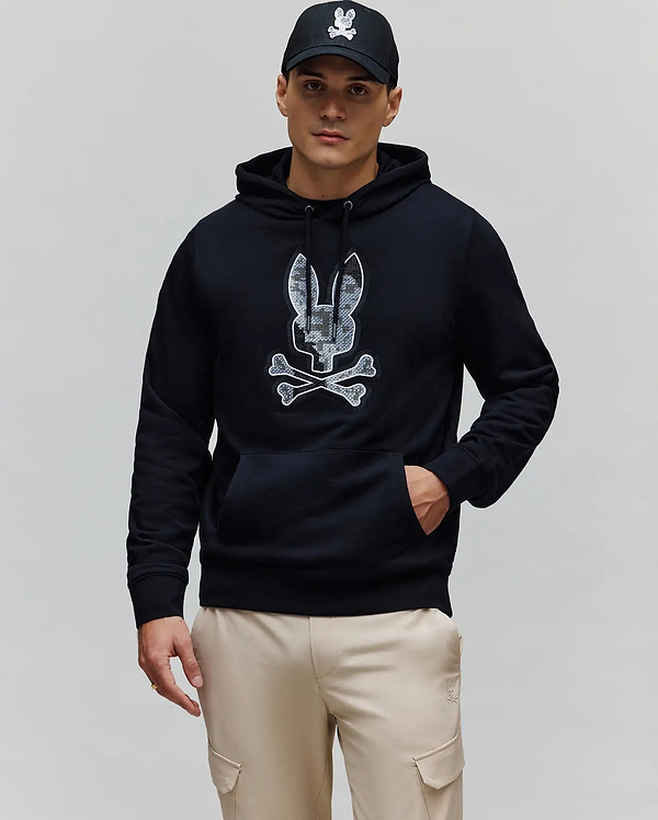 Mens Olivier Embroidered Hoodie, a black classic fit french terry hoodie featuring a large central embroidered Psycho Bunny skull logo with a grey and white camouflage pattern and a front kangaroo pocket.