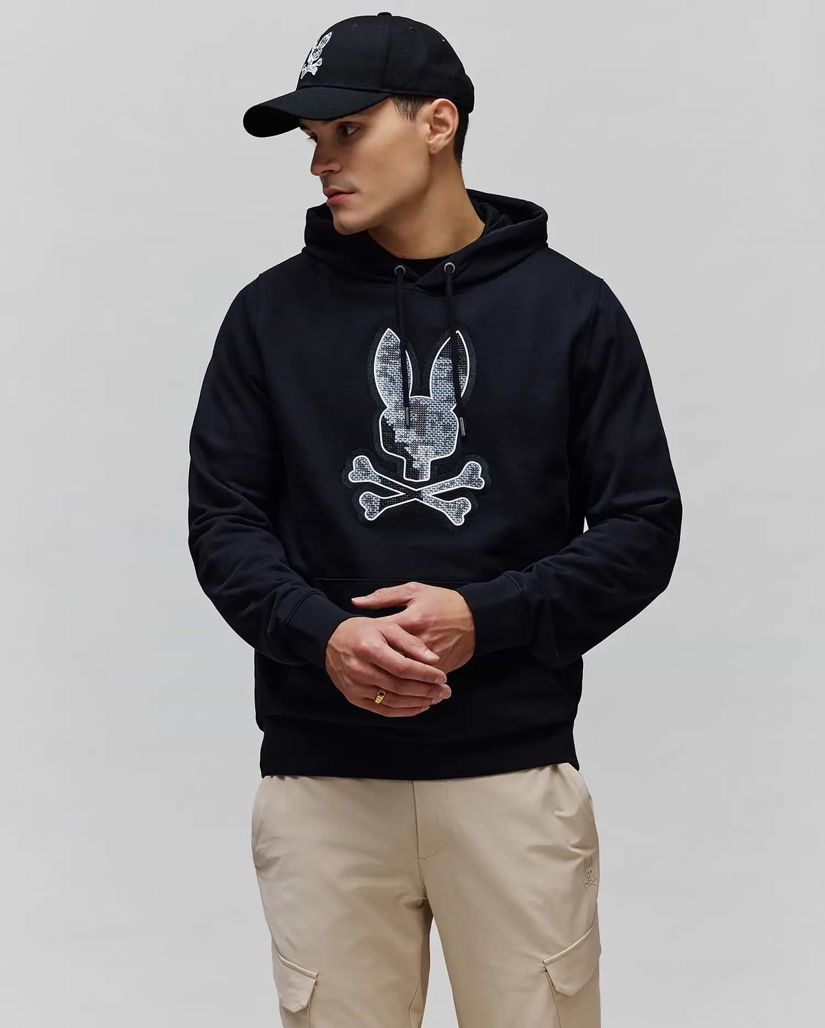 Mens Olivier Embroidered Hoodie in black, featuring a classic fit and soft French terry fabric. A large, textured white and grey Psycho Bunny skull logo is prominently embroidered on the chest.