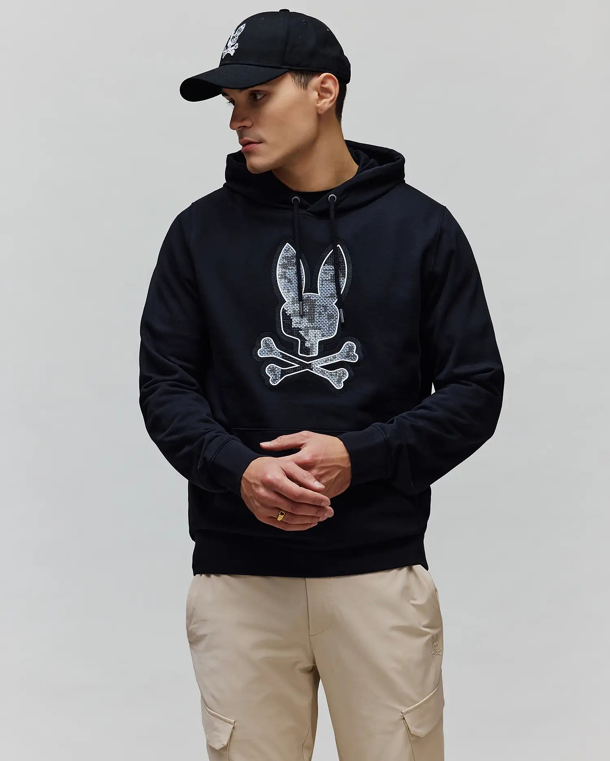 Mens Olivier Embroidered Hoodie in black, featuring a classic fit and soft French terry fabric. A large, textured white and grey Psycho Bunny skull logo is prominently embroidered on the chest.