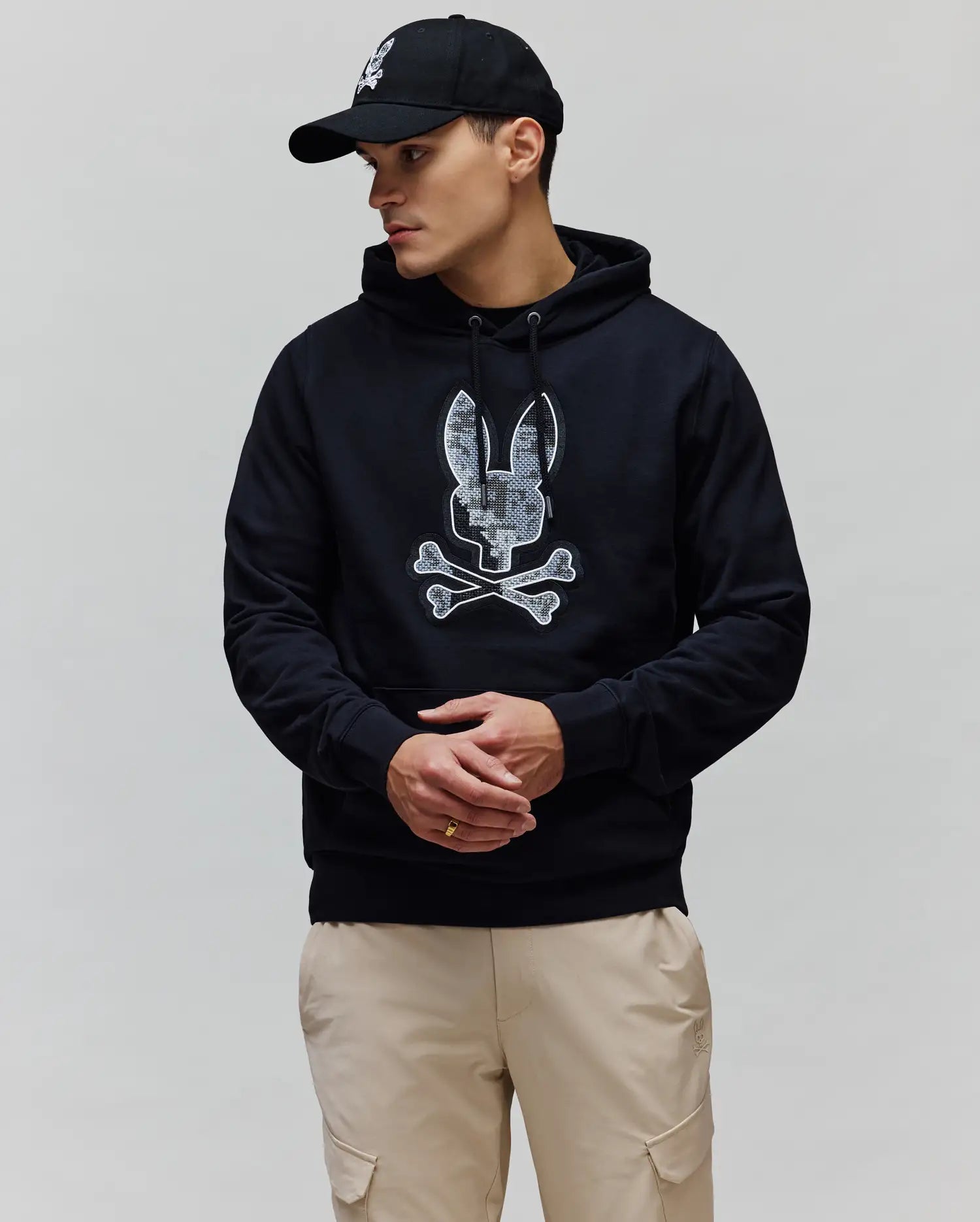 Mens Olivier Embroidered Hoodie in black, featuring a classic fit and soft French terry fabric. A large, textured white and grey Psycho Bunny skull logo is prominently embroidered on the chest.