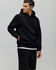 Black Mens Dustin Hoodie featuring a relaxed fit, textured jacquard fabric with an all-over embossed Psycho Bunny skull logo pattern, complete with ribbed cuffs and hem. (3)