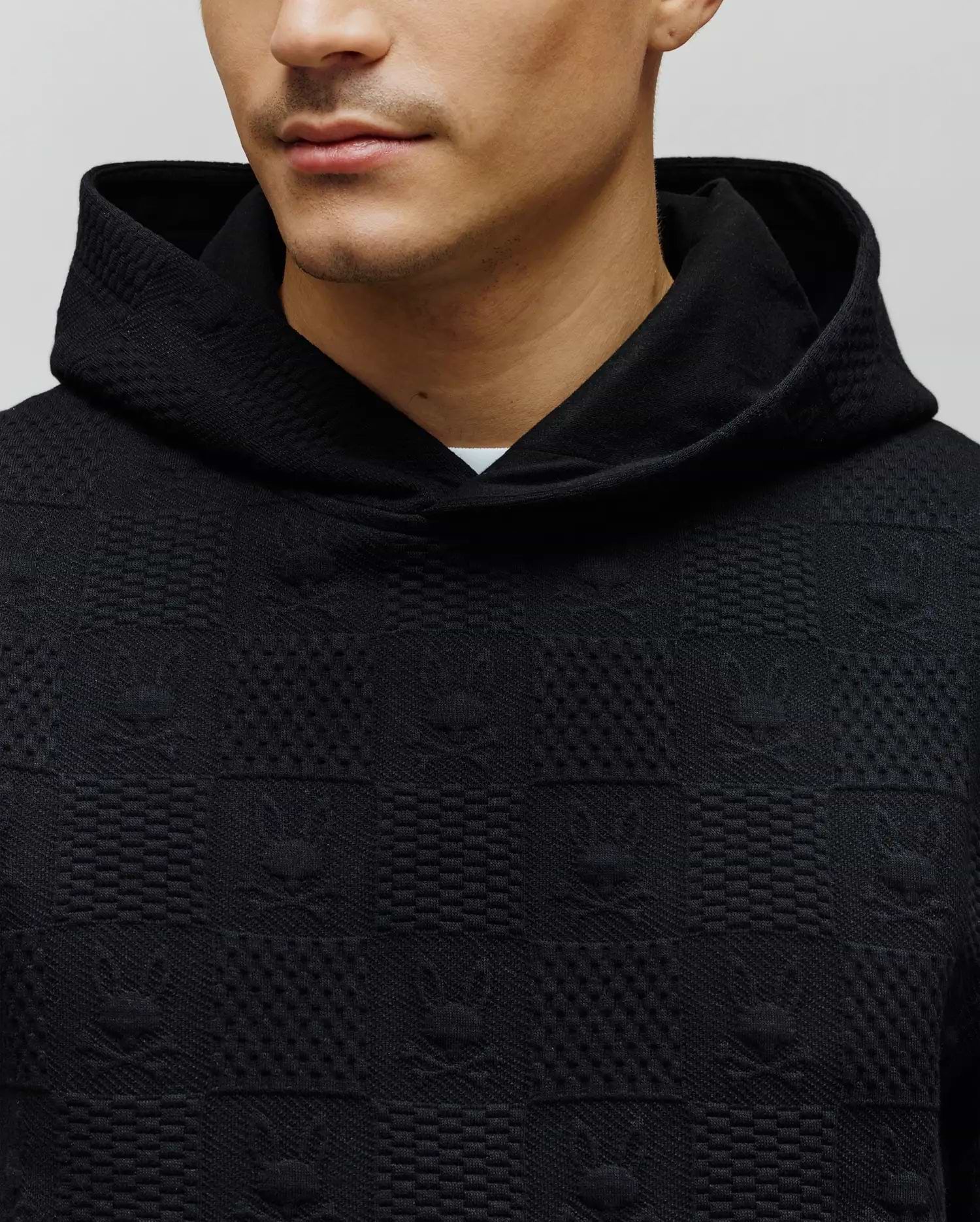Black Mens Dustin Hoodie in a relaxed fit, featuring a unique textured knit with an all-over embossed Psycho Bunny skull and geometric square pattern. (2)