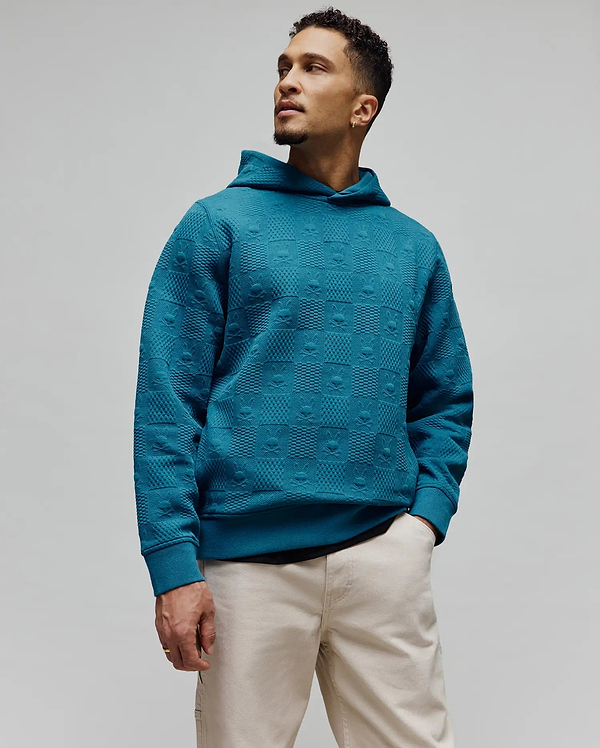 Mens Dustin Hoodie, a relaxed fit teal jacquard knit hoodie featuring an all-over embossed pattern of alternating Psycho Bunny skull logos and textured squares.