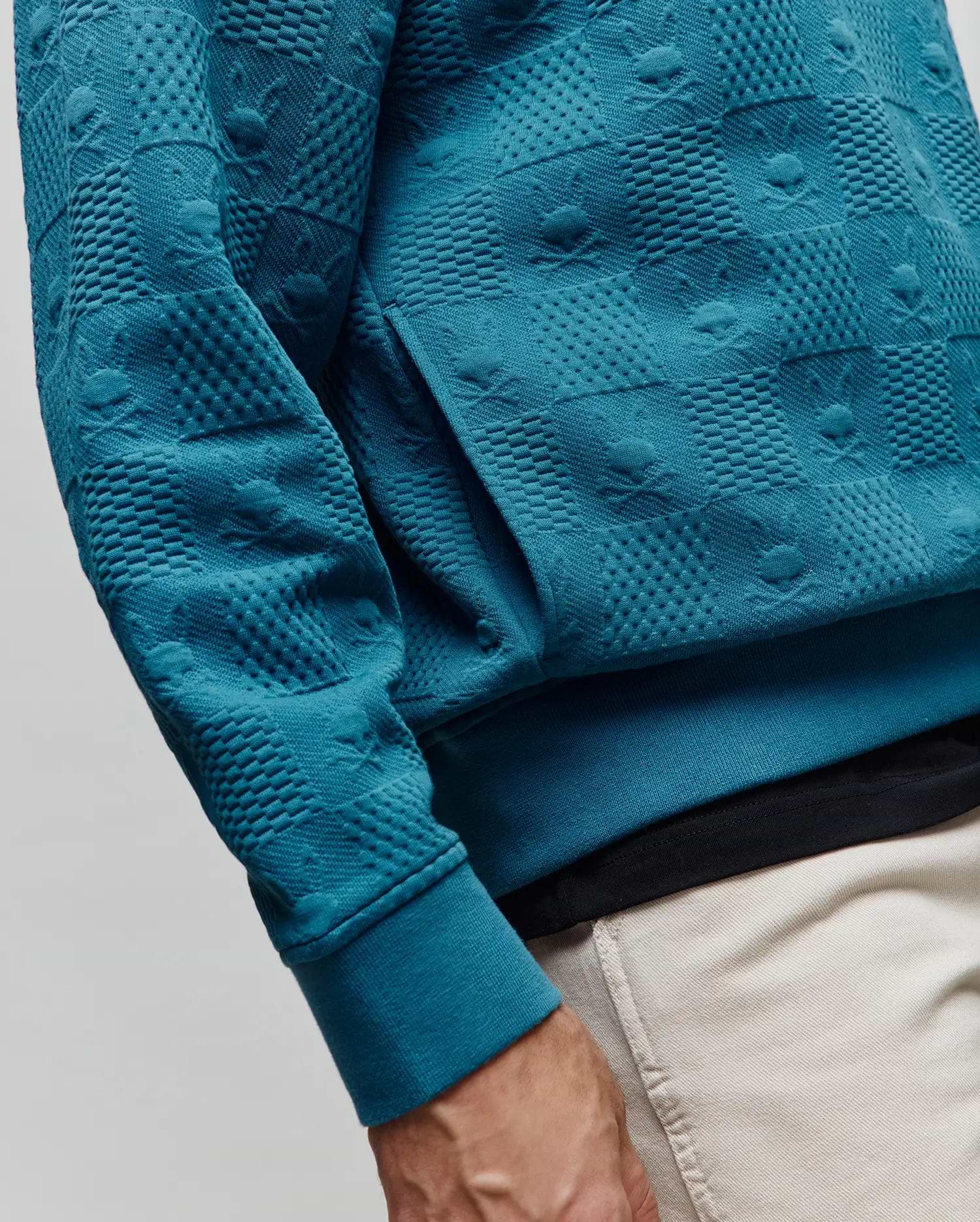 Teal Mens Dustin Hoodie featuring a unique all-over embossed texture with alternating squares of raised dots and subtle Psycho Bunny skull logos, classic fit, ribbed cuffs, and a front kangaroo pocket.