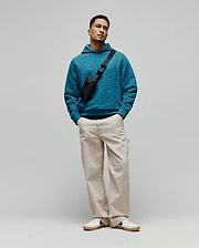 Vibrant teal Mens Dustin Hoodie, a relaxed fit, textured knit hoodie featuring an all-over embossed Psycho Bunny skull logo pattern for refined streetwear style.