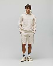 Cream Mens Dustin Hoodie and matching shorts, both featuring a relaxed fit and an allover embossed Psycho Bunny skull pattern on textured French terry fabric.