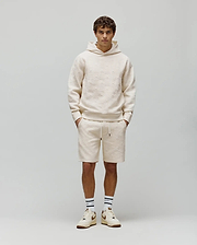 Cream Mens Dustin Hoodie and matching shorts, both featuring a relaxed fit and an allover embossed Psycho Bunny skull pattern on textured French terry fabric.