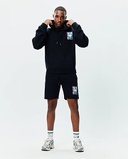 Black relaxed fit French terry hoodie and shorts set featuring a vibrant Psycho Bunny skull logo print on the left chest and left thigh, with drawstrings and a kangaroo pocket. Mens Isaac Print Hoodie.