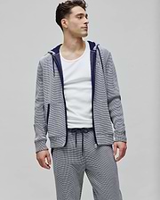 Mens Maxton Waffle Full Zip Hoodie in navy and white micro-stripe waffle knit, featuring a classic fit, small embroidered Psycho Bunny skull logo on the left chest, navy zipper, and orange hood trim.
