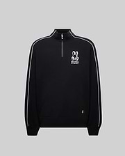 Mens Toby 1/4 Zip, a black relaxed-fit smooth knit pullover with a stand collar, white piping on sleeves, a kangaroo pocket, and a prominent white embroidered Psycho Bunny skull and crossbones logo on the chest, accented by a neon green tag.