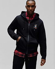 Mens Raphael Zip Hoodie in black, featuring a classic fit, smooth jersey fabric, full zip closure, drawstring hood, and a small, multicolor embroidered Psycho Bunny skull logo on the left chest.