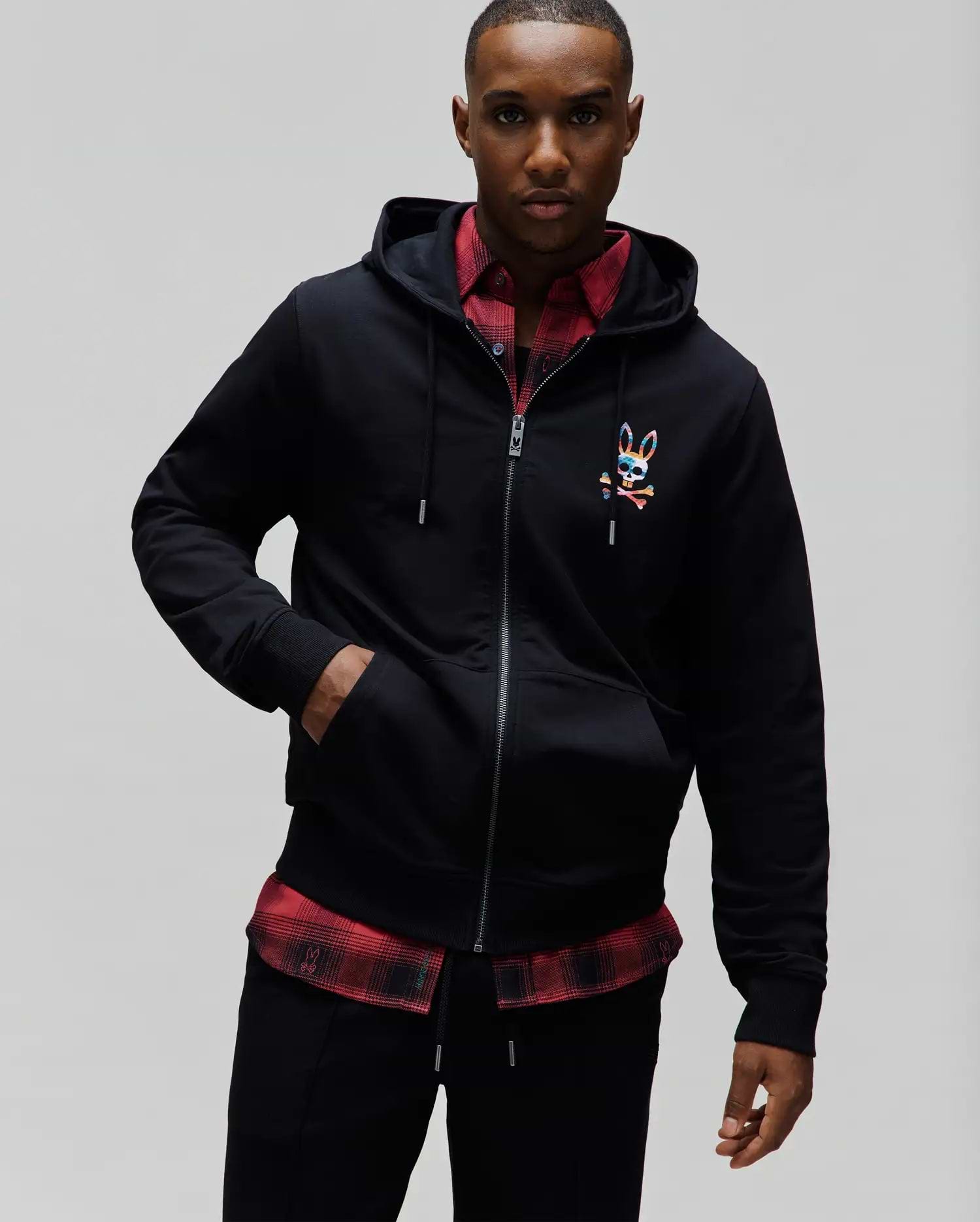 Mens Raphael Zip Hoodie in black, featuring a classic fit, smooth jersey fabric, full zip closure, drawstring hood, and a small, multicolor embroidered Psycho Bunny skull logo on the left chest.