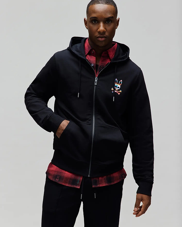 Mens Raphael Zip Hoodie in black, featuring a classic fit, smooth jersey fabric, full zip closure, drawstring hood, and a small, multicolor embroidered Psycho Bunny skull logo on the left chest.