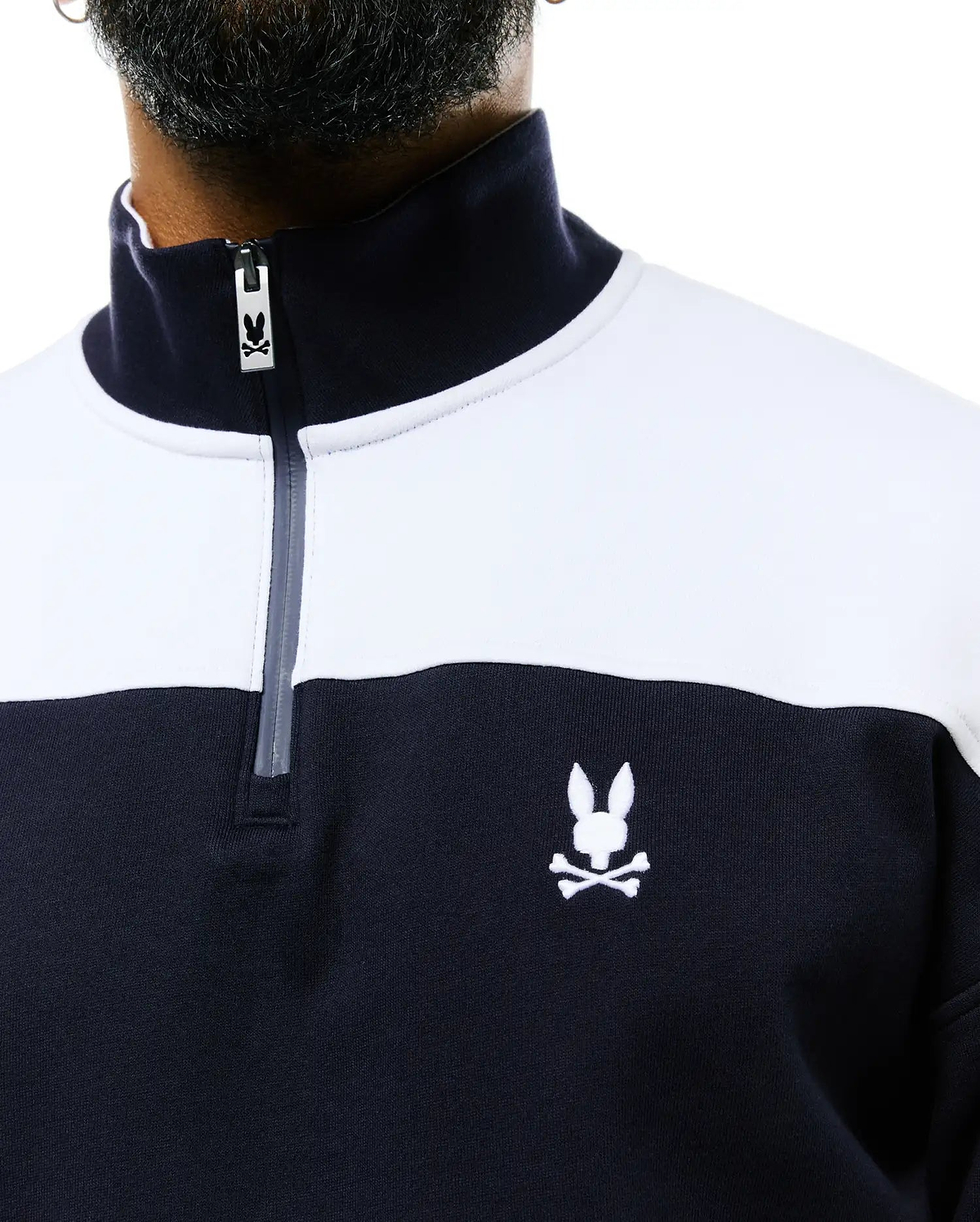 Mens Gabe French Terry 1/4 Zip in a classic fit, featuring a navy and white color block design, soft French terry fabric, and an embroidered white Psycho Bunny skull logo on the left chest, with a branded zipper pull.