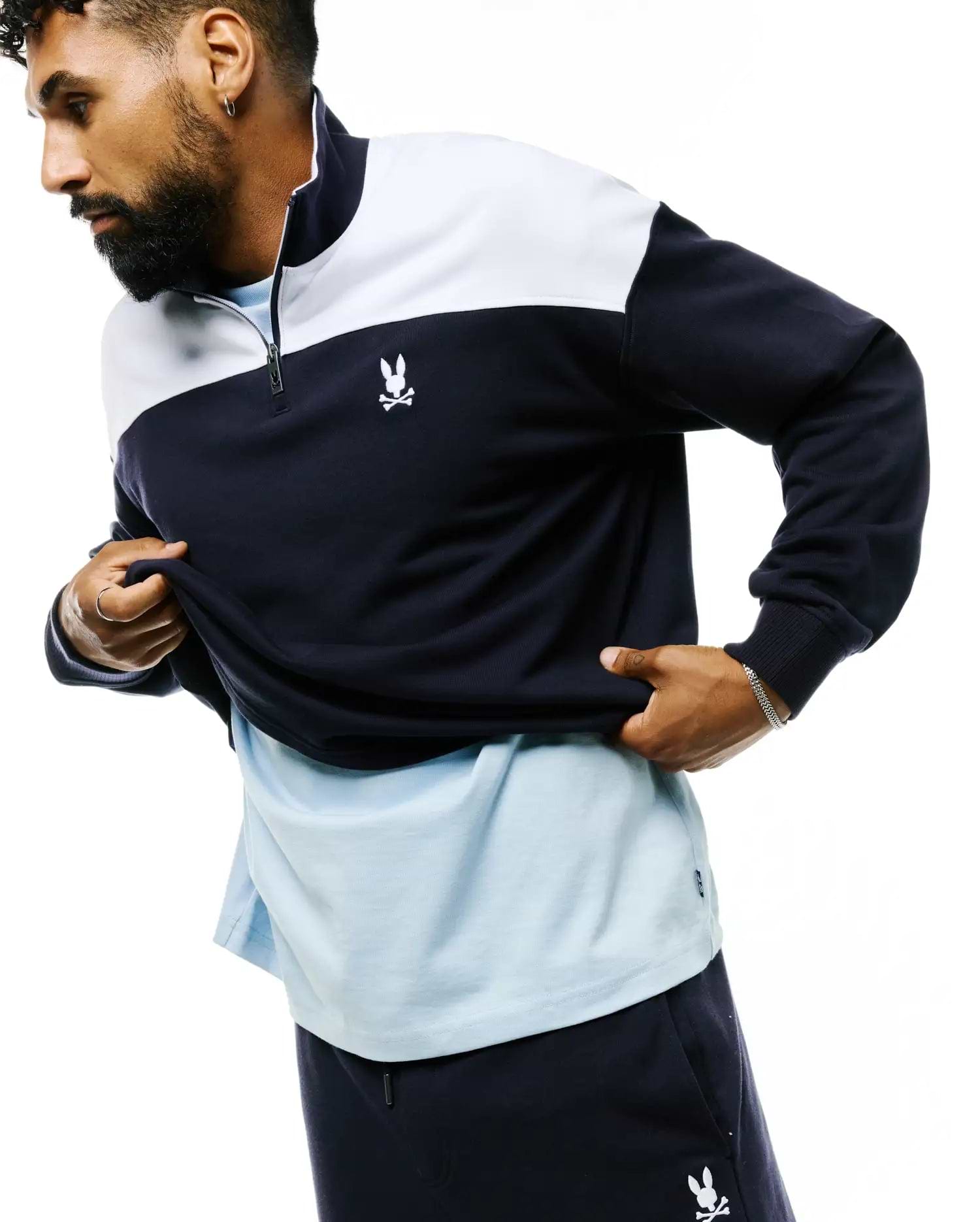 Mens Gabe French Terry 1/4 Zip in a classic fit, featuring a navy and white color block design, stand-up collar, and a small embroidered white Psycho Bunny skull logo on the left chest.