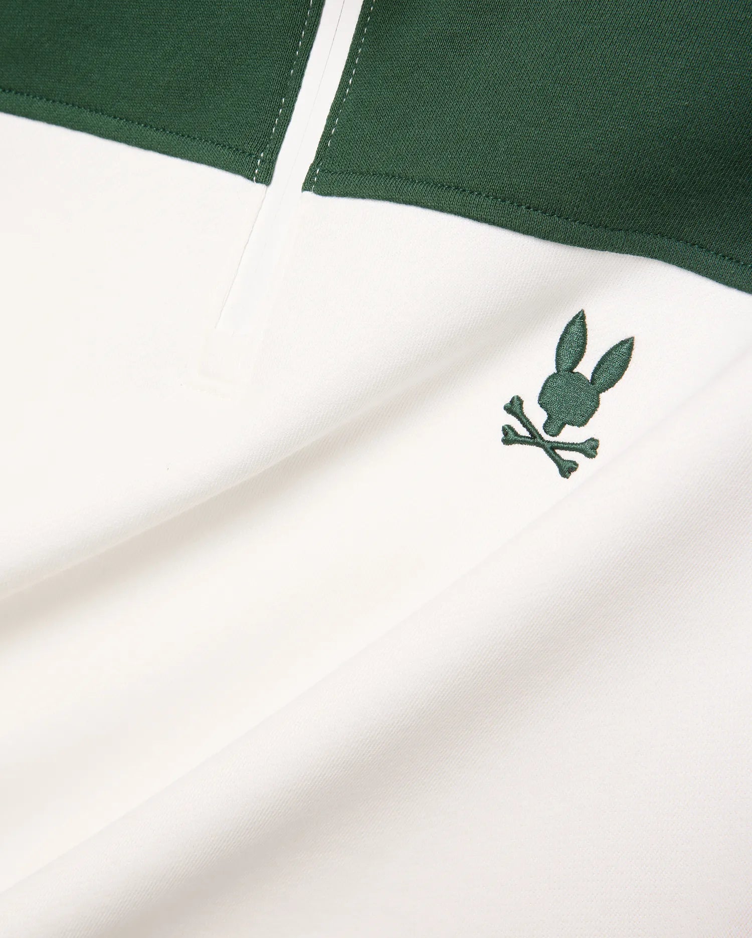 Mens Gabe French Terry 1/4 Zip, a white and dark green color-block design with a small, embroidered dark green Psycho Bunny skull logo on the chest. Soft French terry fabric.