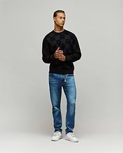 Black Mens Gio All Over Flock Crew sweatshirt with a classic fit, featuring an all-over flocked checkerboard pattern incorporating the iconic Psycho Bunny skull logo.