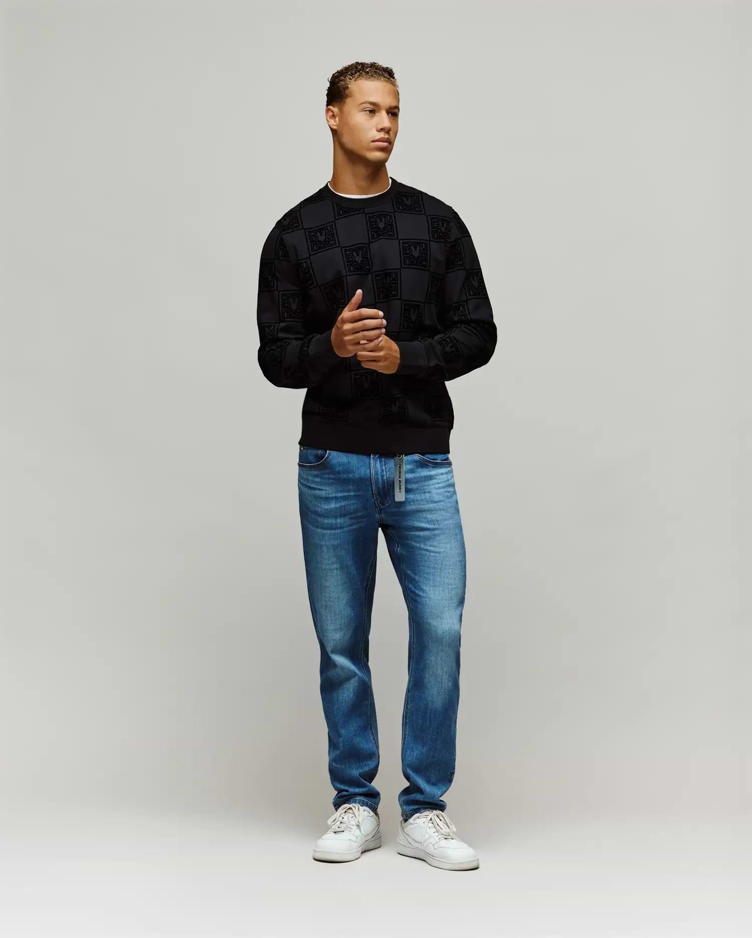 Black Mens Gio All Over Flock Crew sweatshirt with a classic fit, featuring an all-over flocked checkerboard pattern incorporating the iconic Psycho Bunny skull logo.