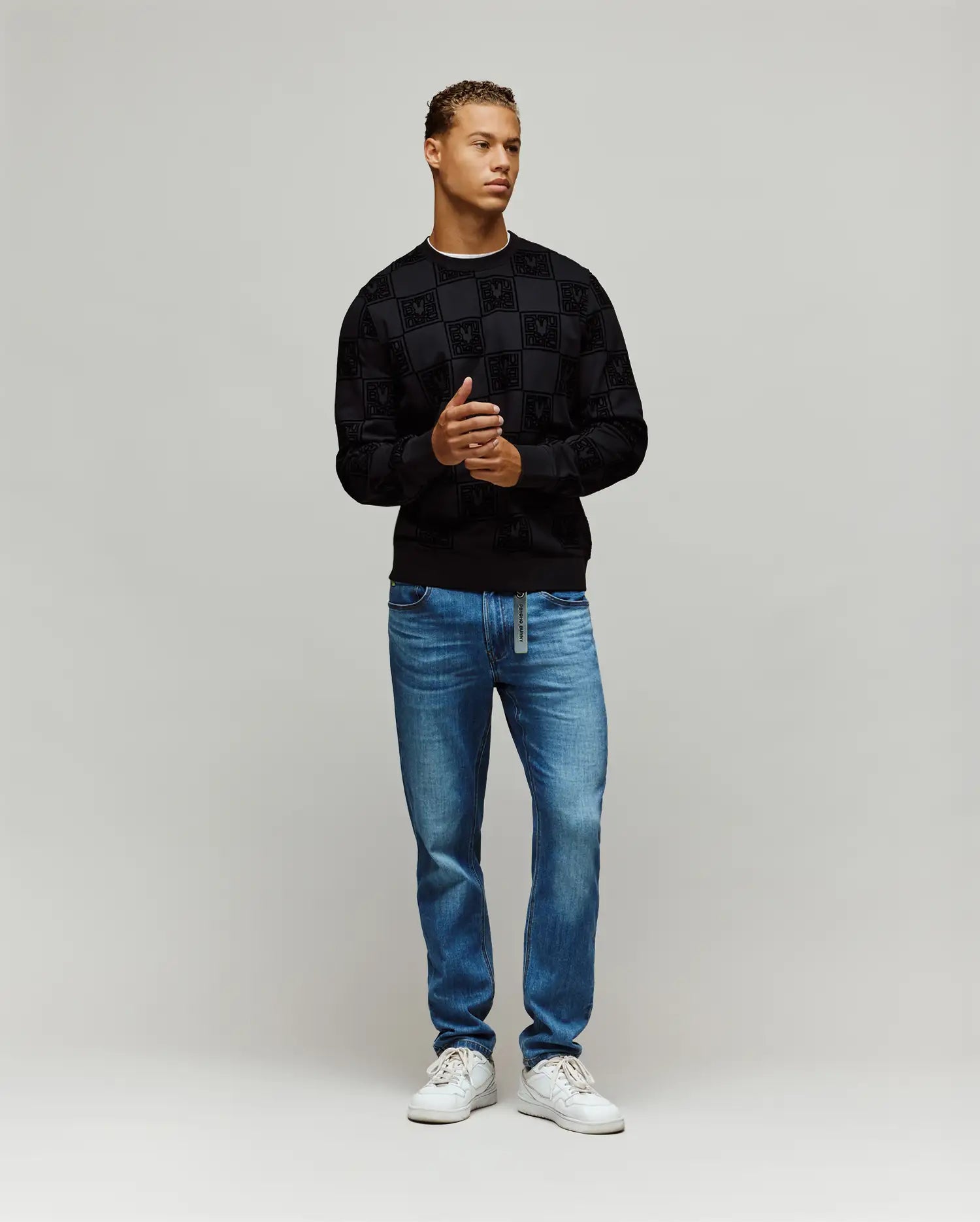 Black Mens Gio All Over Flock Crew sweatshirt with a classic fit, featuring an all-over flocked checkerboard pattern incorporating the iconic Psycho Bunny skull logo.