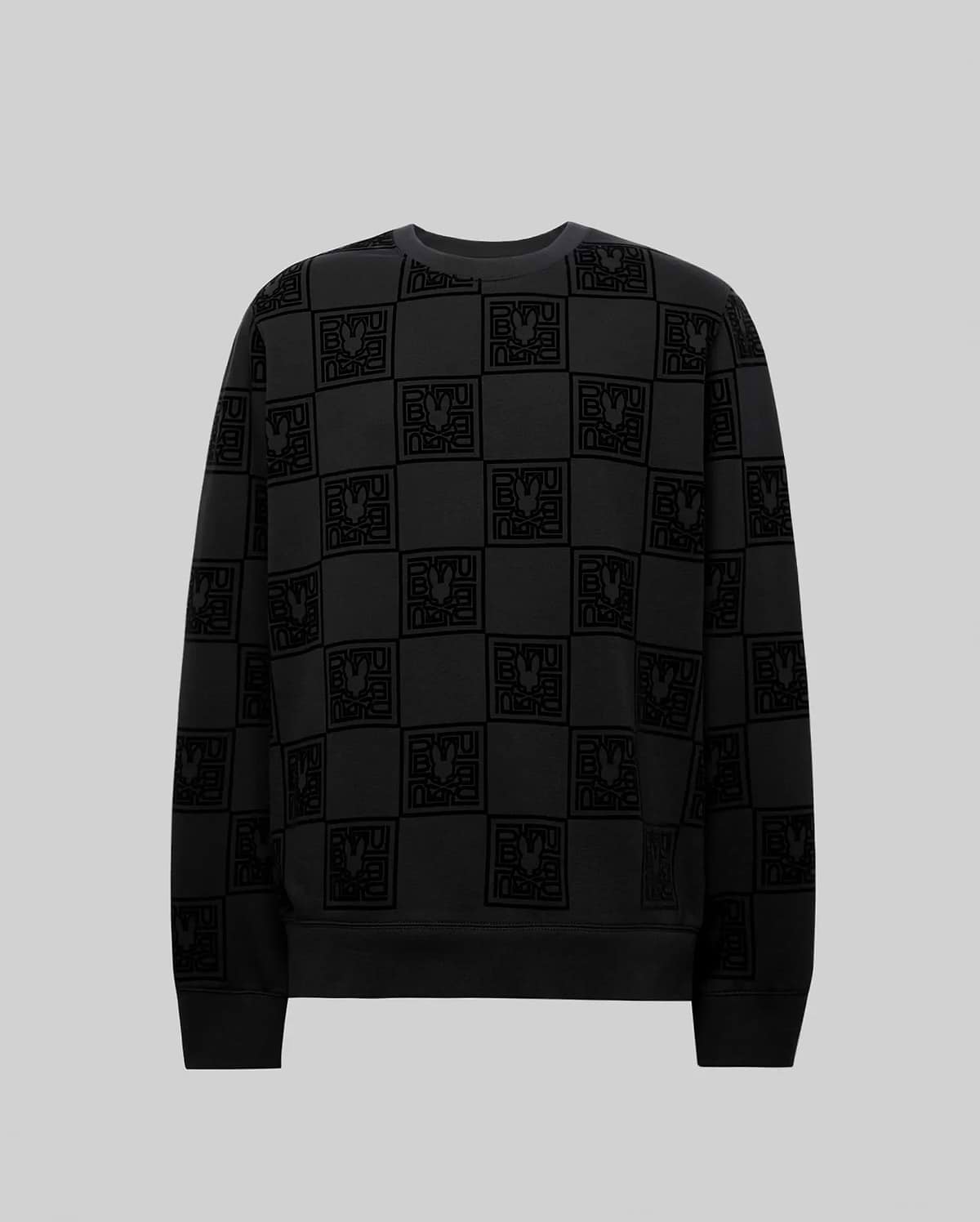 Mens Gio All Over Flock Crew, a black relaxed-fit jersey crewneck sweatshirt featuring an all-over tonal flocked checkerboard pattern of the iconic Psycho Bunny skull logo and stylized text.