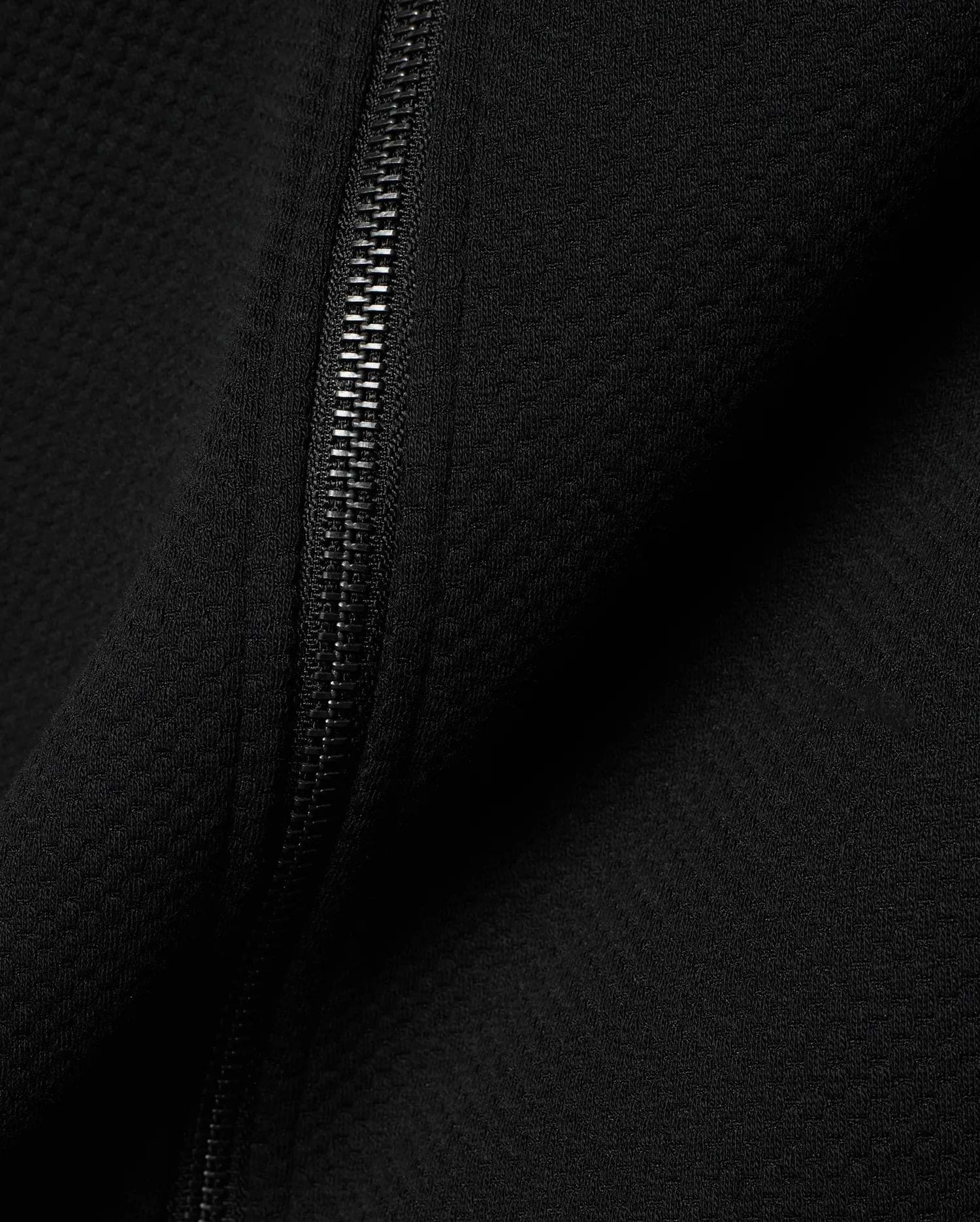 Mens Marc Textured Full Zip Hoodie in deep black, showcasing its refined waffle knit fabric texture and a sleek, dark metallic full-length zipper detail.