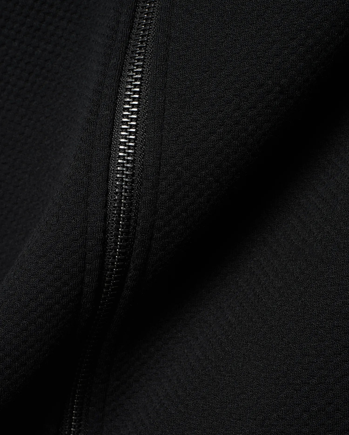Mens Marc Textured Full Zip Hoodie in deep black, showcasing its refined waffle knit fabric texture and a sleek, dark metallic full-length zipper detail.