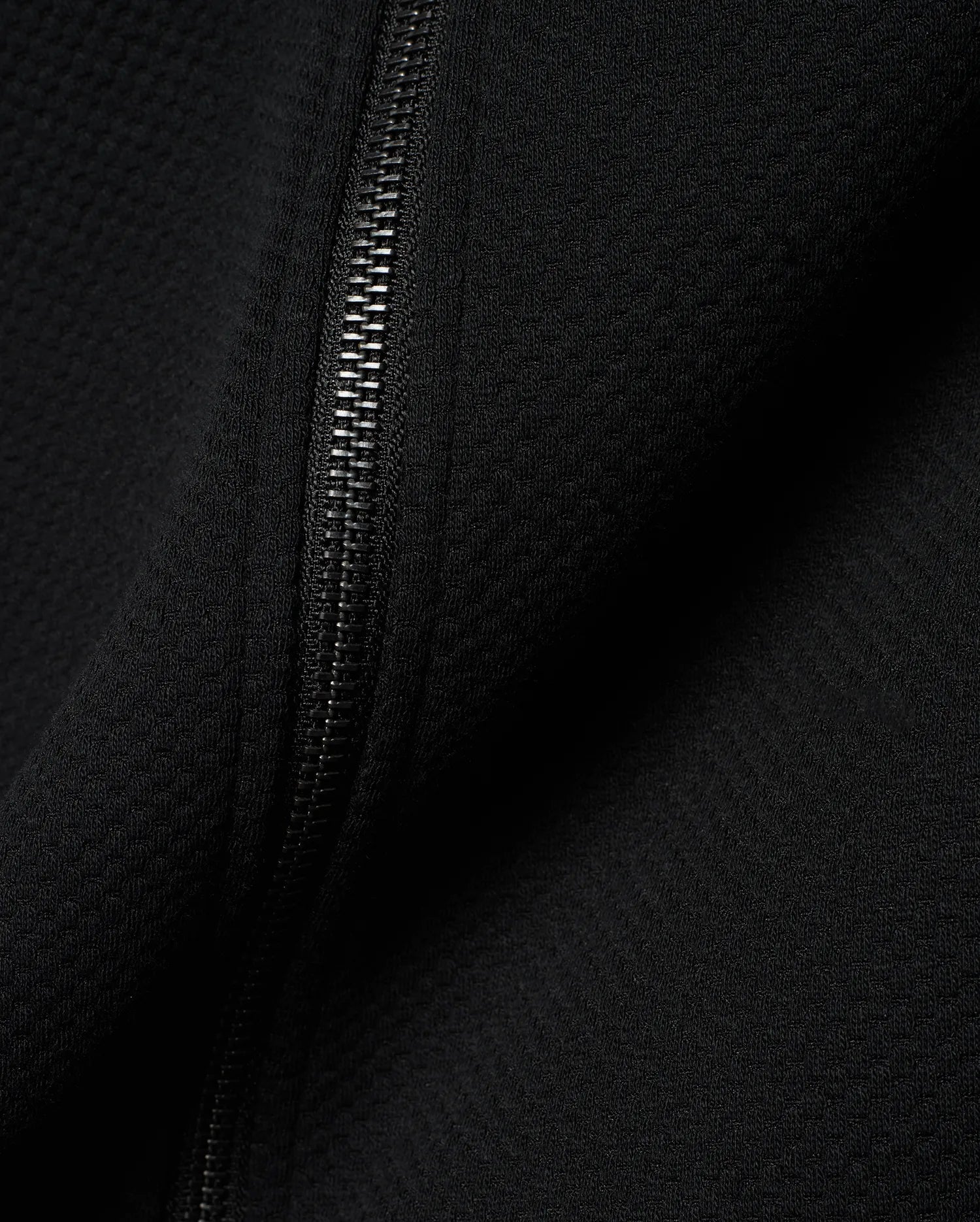 Mens Marc Textured Full Zip Hoodie in deep black, showcasing its refined waffle knit fabric texture and a sleek, dark metallic full-length zipper detail.