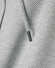 Mens Marc Textured Full Zip Hoodie in light grey with a distinct checkered knit pattern, featuring a dark zipper and a drawstring with an engraved Psycho Bunny metallic tip.