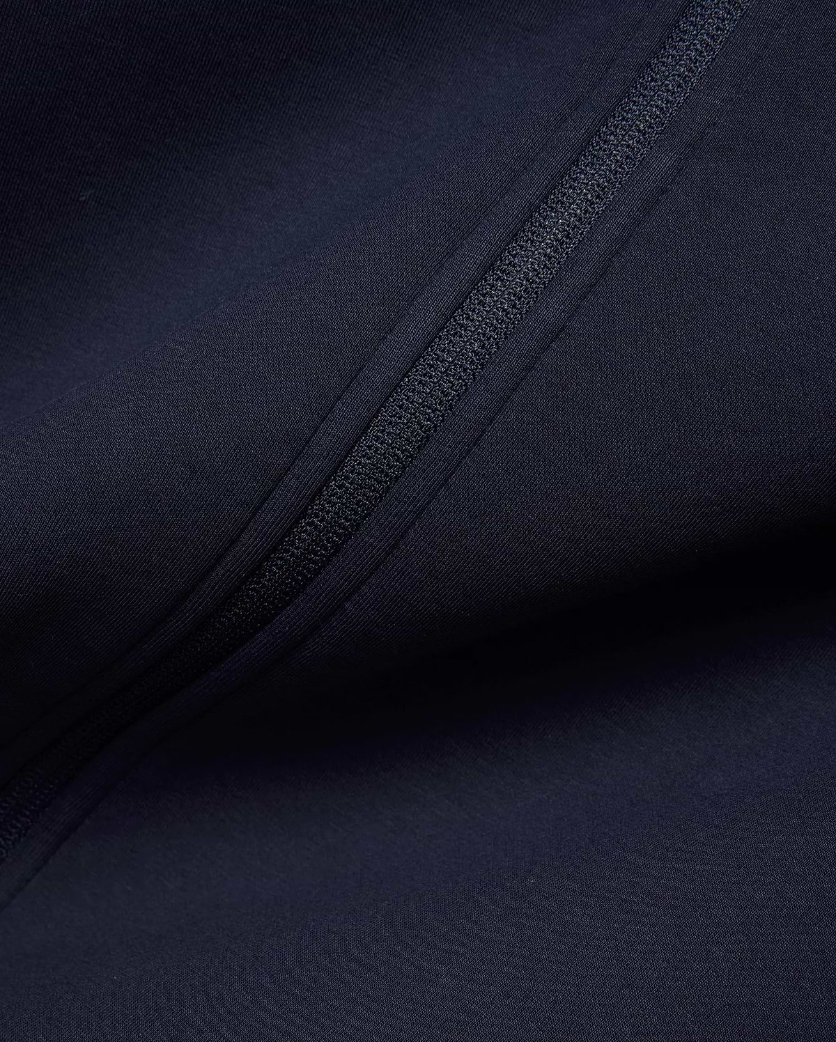 Mens Jaydon Track Jacket in deep navy, crafted from a smooth, performance-ready knit fabric, featuring a sleek, tonal full-zip closure for a refined streetwear look. (6)