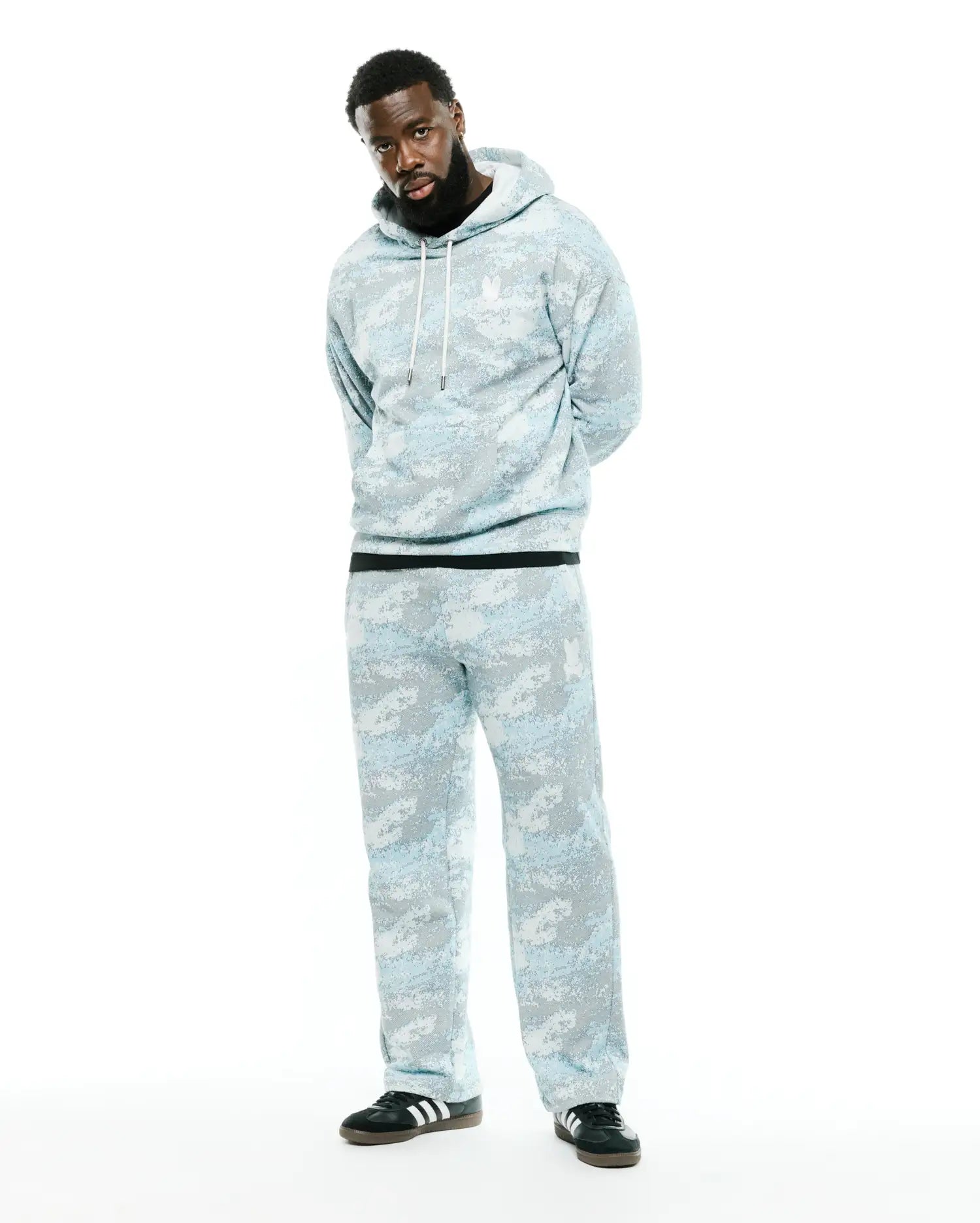 Men's Alfie All-Over Print Hoodie, a relaxed fit light blue and grey digital camo print hoodie with white drawstrings and a small embroidered white Psycho Bunny skull logo on the left chest. (1)