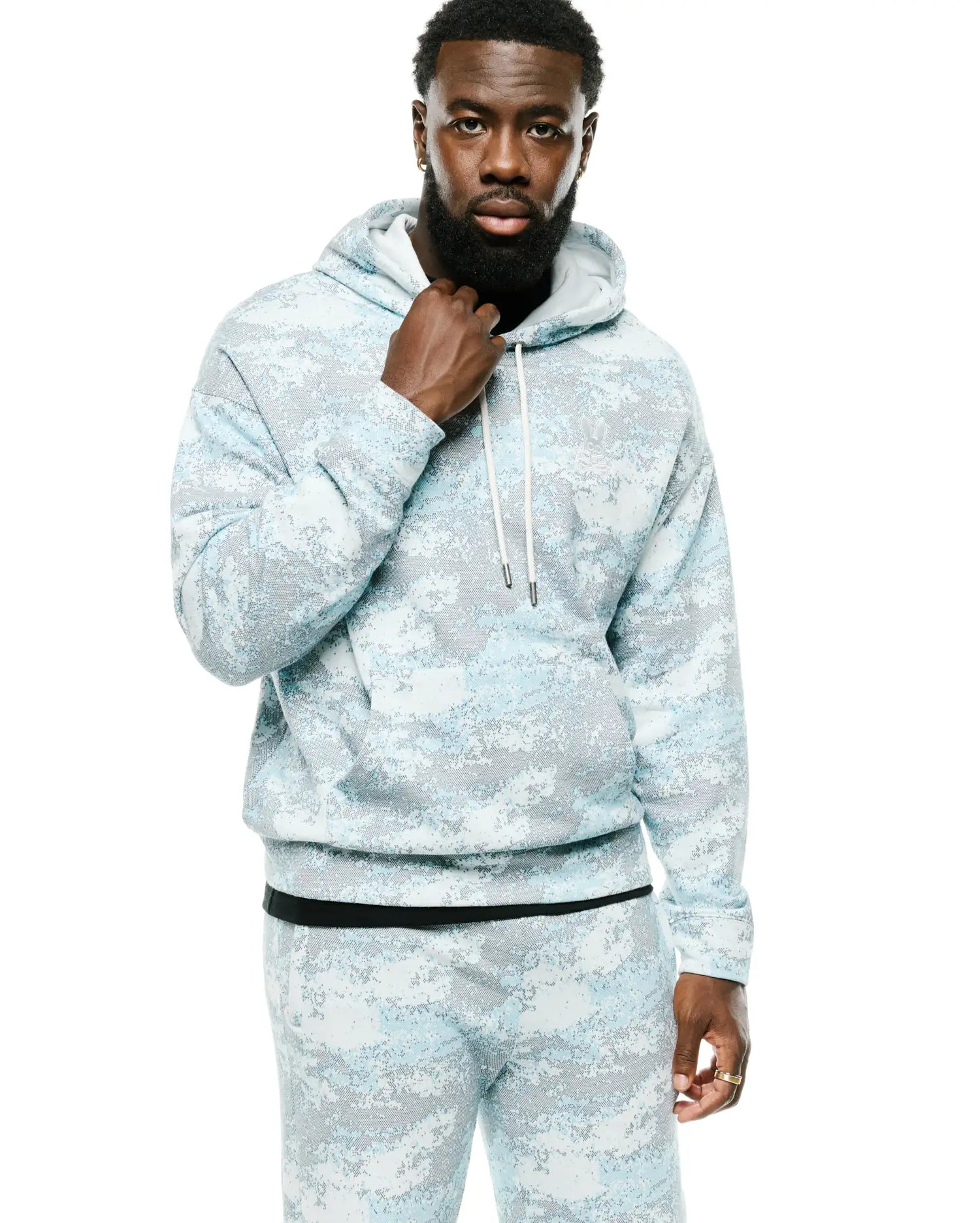 Men's Alfie All-Over Print Hoodie, a relaxed fit light blue and grey digital camo french terry hoodie featuring an embroidered Psycho Bunny skull logo on the left chest, white drawstrings, and a front pouch pocket. (2)