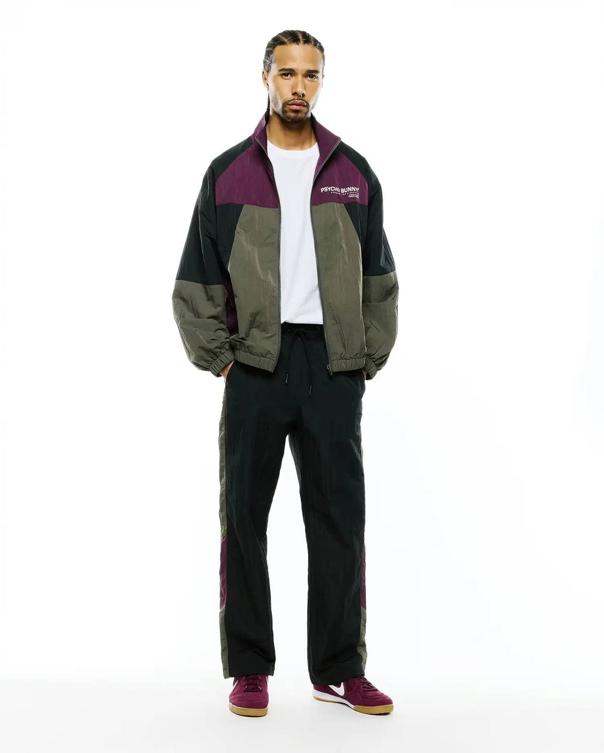 Mens Alder Nylon Colorblock Jacket, a relaxed fit crinkled nylon jacket in dark green, black, and plum, featuring a white Psycho Bunny text logo on the left chest.