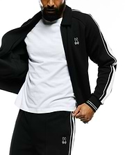 Mens Ceano Track Jacket: Black smooth knit full-zip jacket with classic collar, white double stripes on sleeves, and ribbed cuffs. Features a small white embroidered Psycho Bunny skull logo on the left chest.